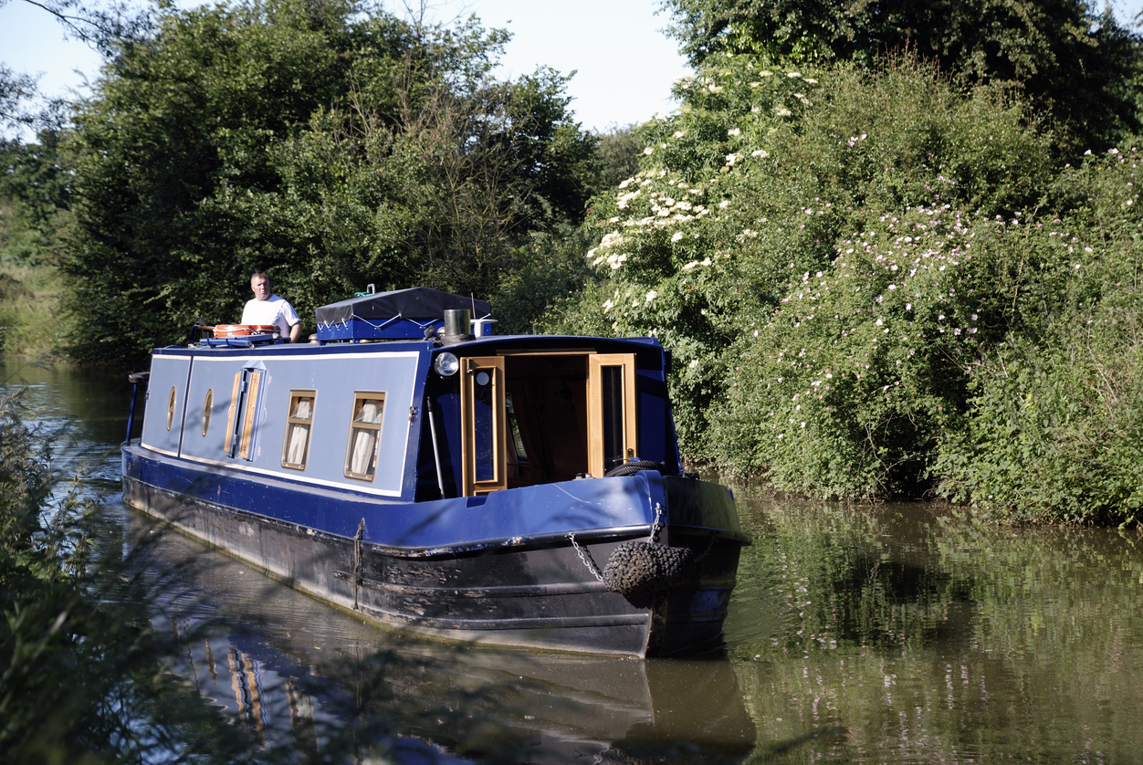 Man riding on narrowboat