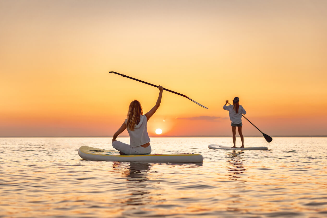 arm-paddle-boarding-sunset